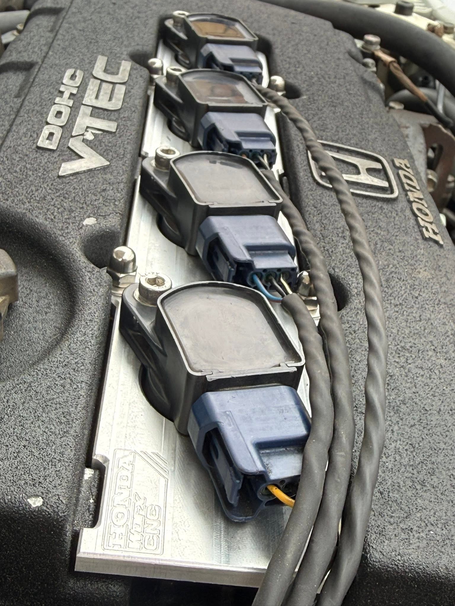 Four ignition coils on a HondaWorx machined adapter plate on the B16 engine.
