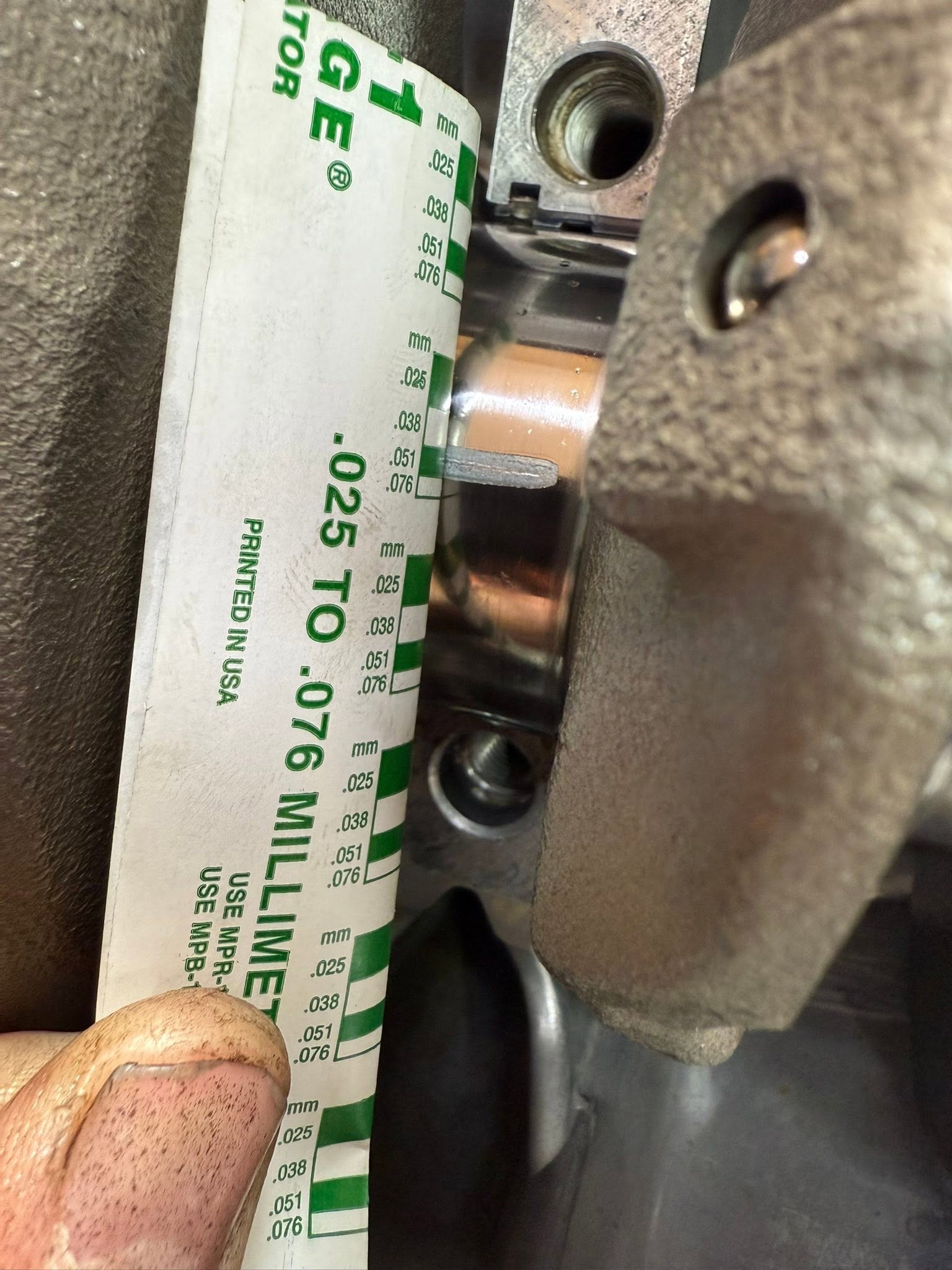 Bearing clearance being compared against a measuring scale.