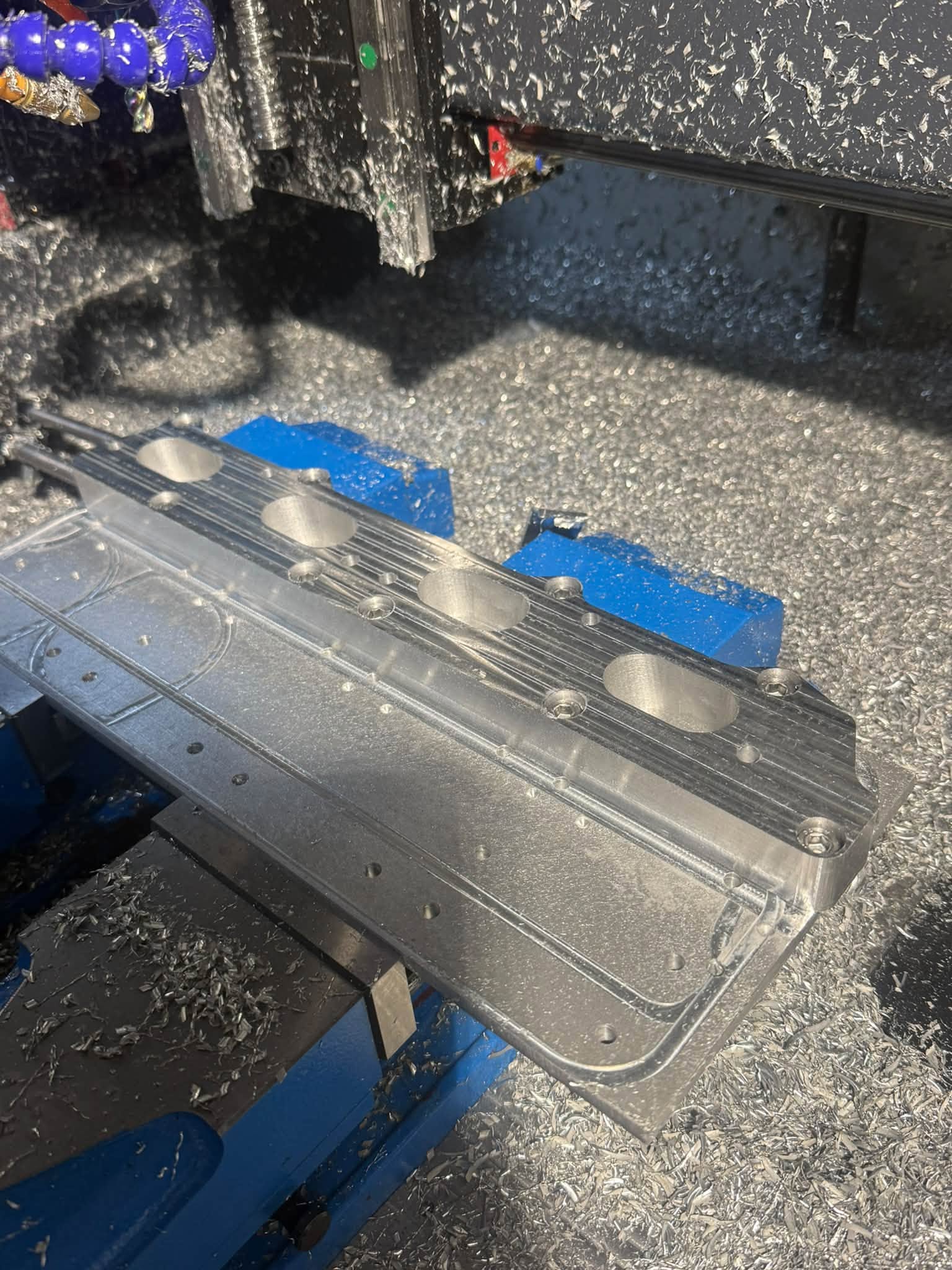 Aluminium adapter in the CNC mill during machining.