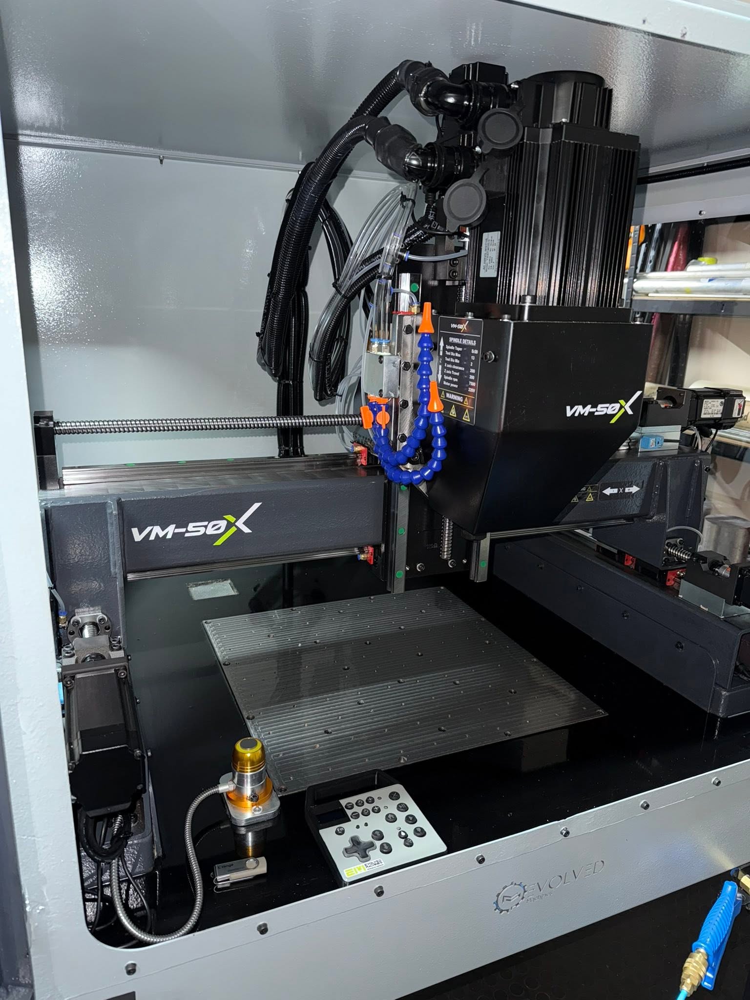 HondaWorx VM-50X CNC mill with spindle, coolant nozzles and machining table.