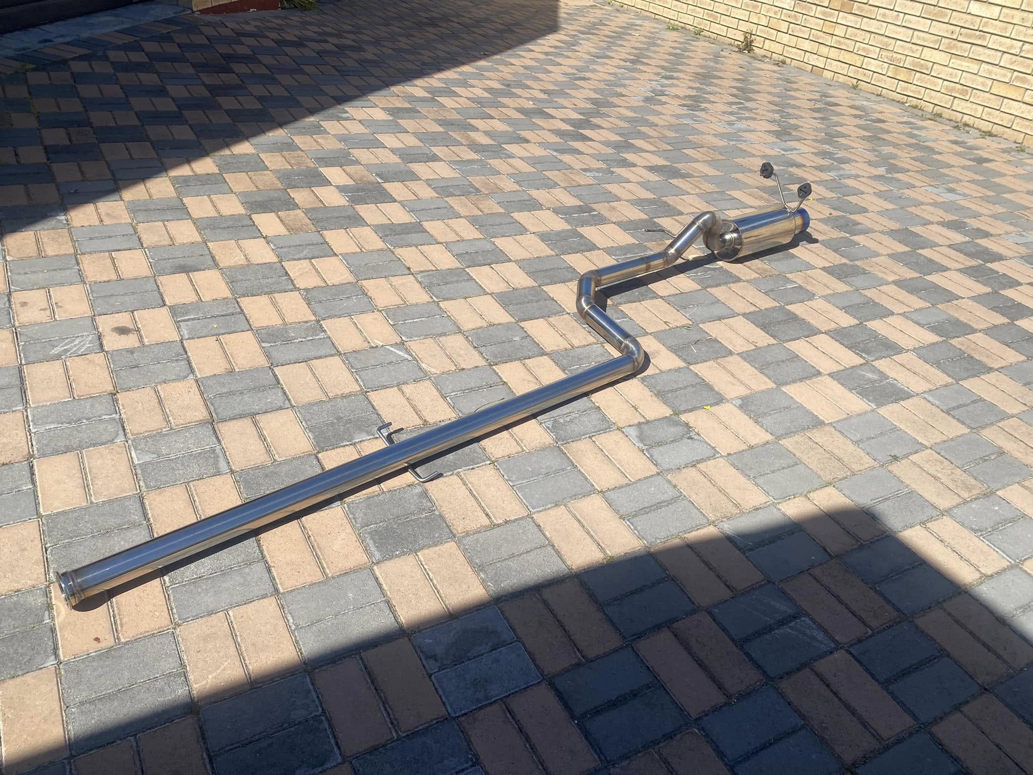 Complete custom exhaust assembly laid out with its bends, silencer and mounting points.