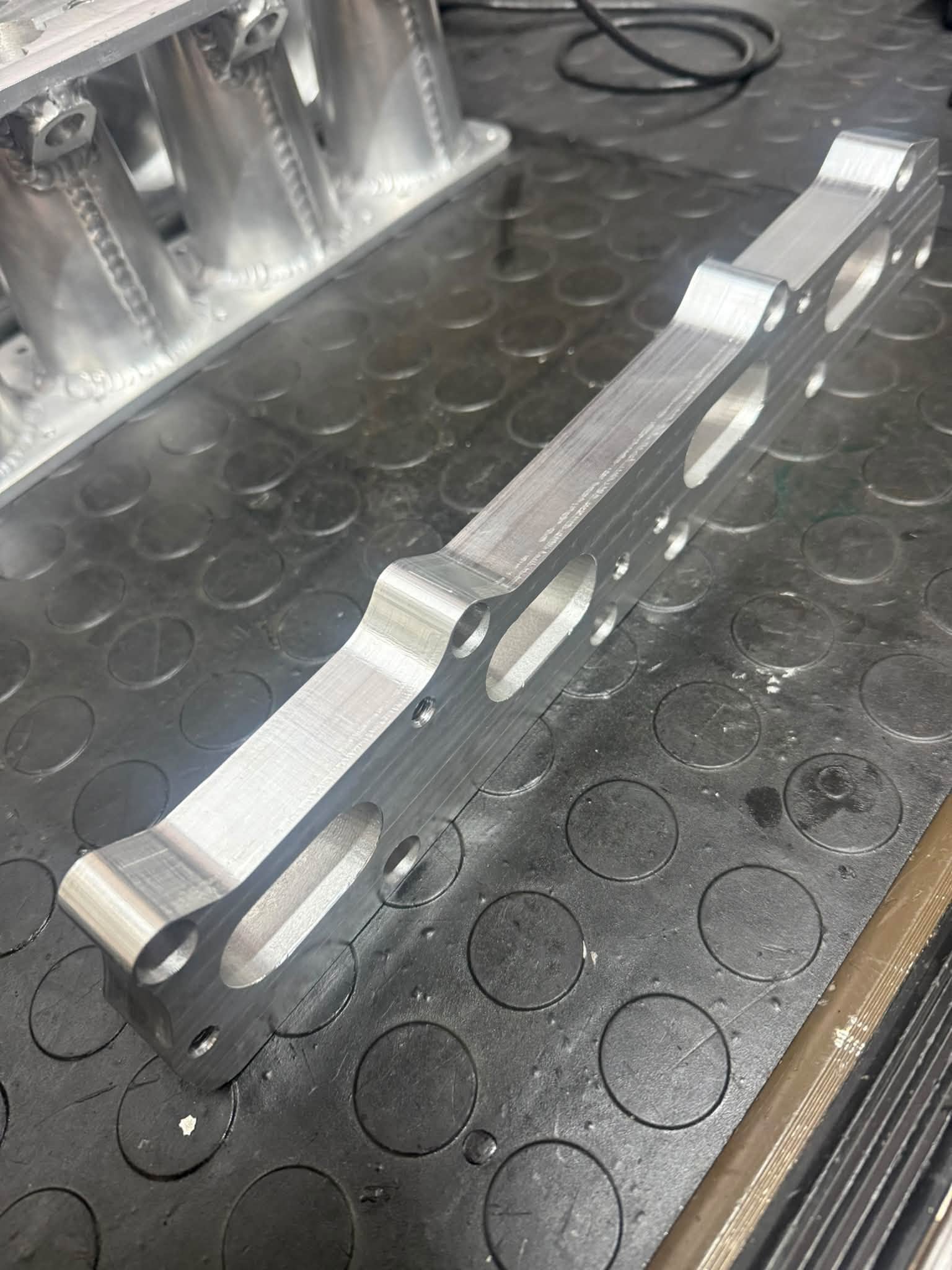 Finished CNC-machined aluminium throttle-body adapter plate.